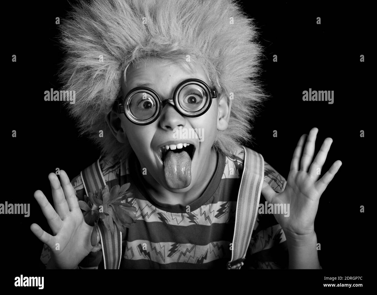 Portrait Of Funny Boy Sticking Out Tongue While Wearing Eyeglasses And