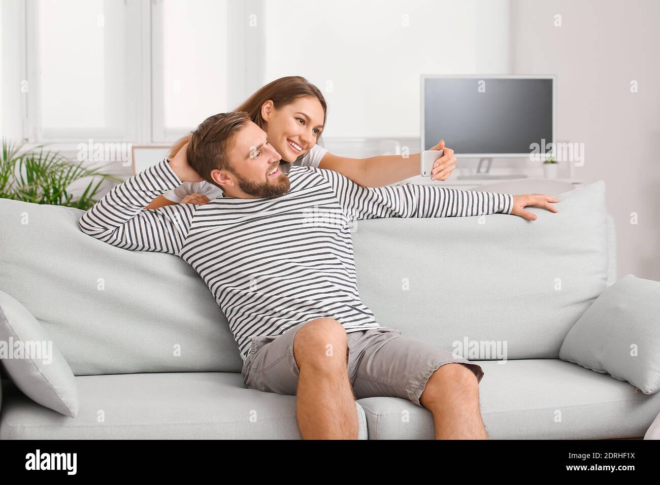 Young couple taking selfie at home Stock Photo - Alamy