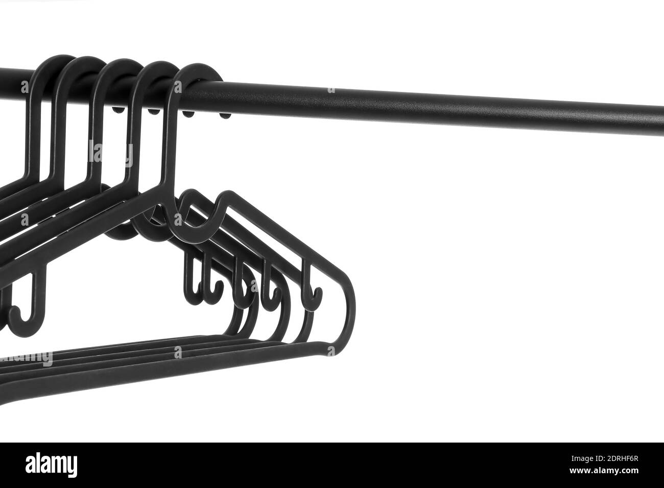 Rack with clothes hangers on white background Stock Photo - Alamy