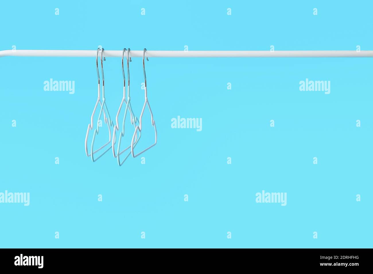 Rack with clothes hangers on color background Stock Photo - Alamy