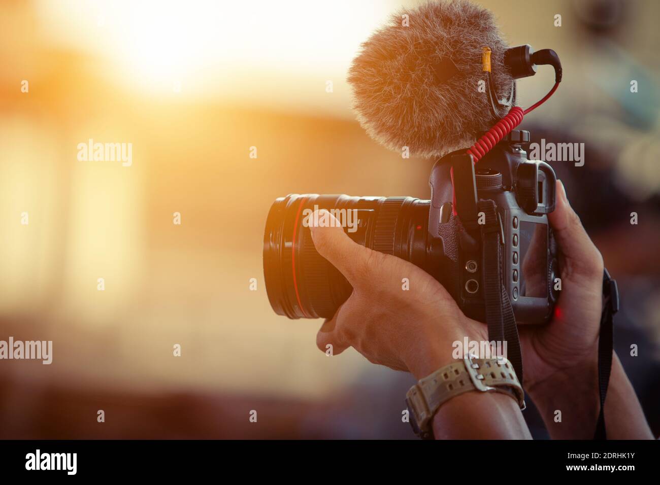 Blogger content creator camera handheld shooting video footage Stock Photo