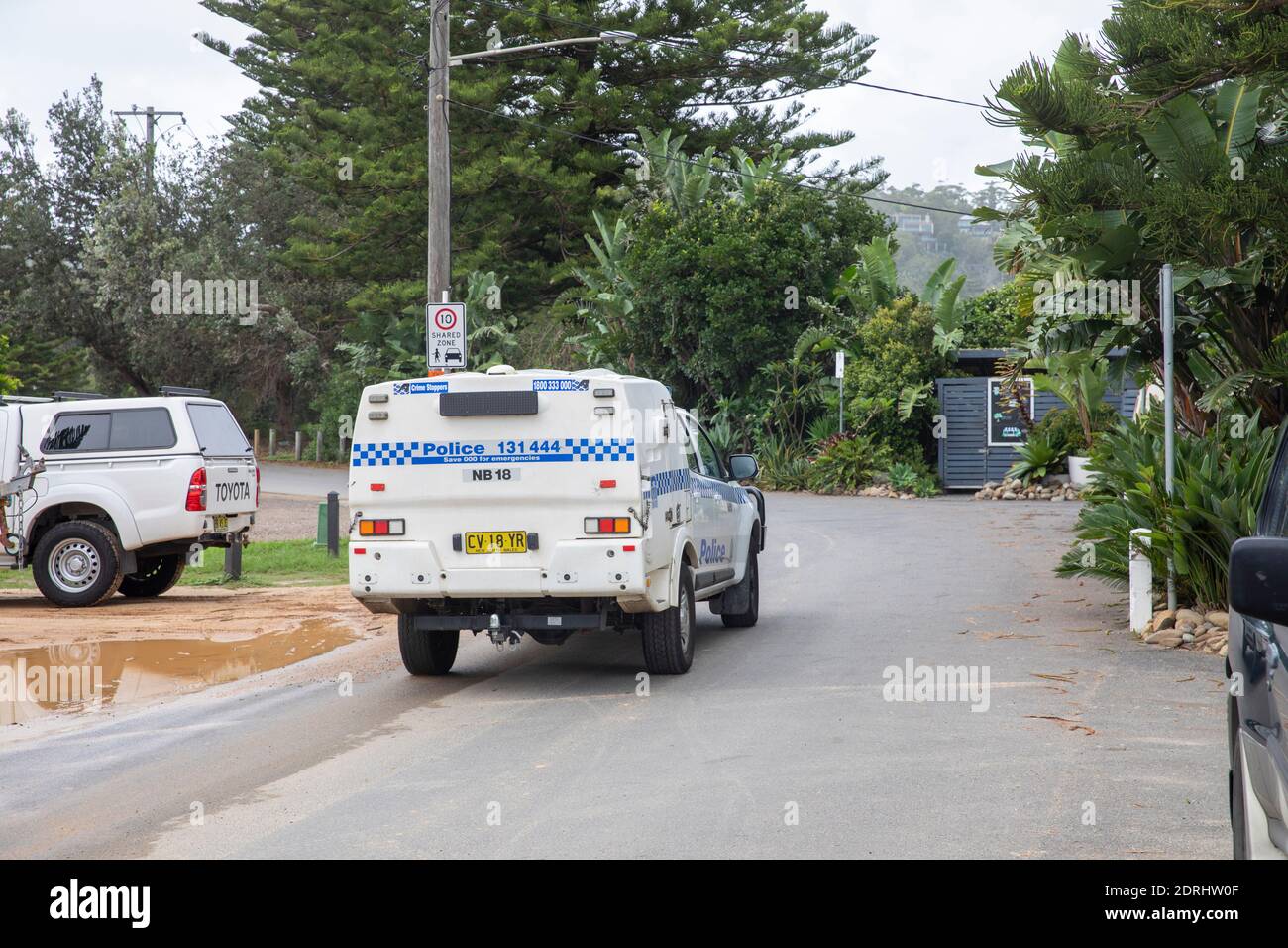 NSW police vehicle travelling through Palm beach in Sydney,Australia Stock Photo