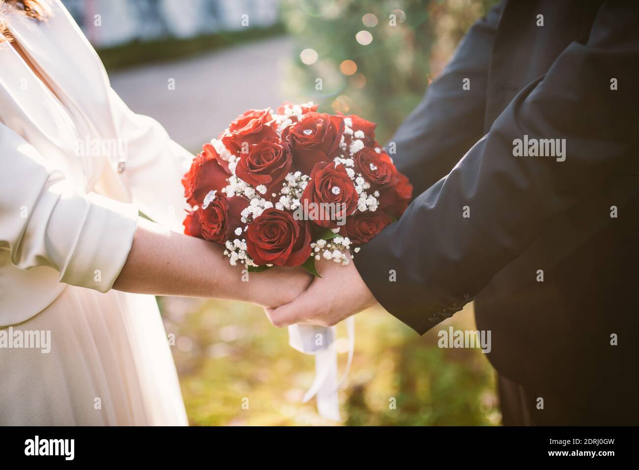 Wedding couple holding wedding flowers Stock Photo Alamy