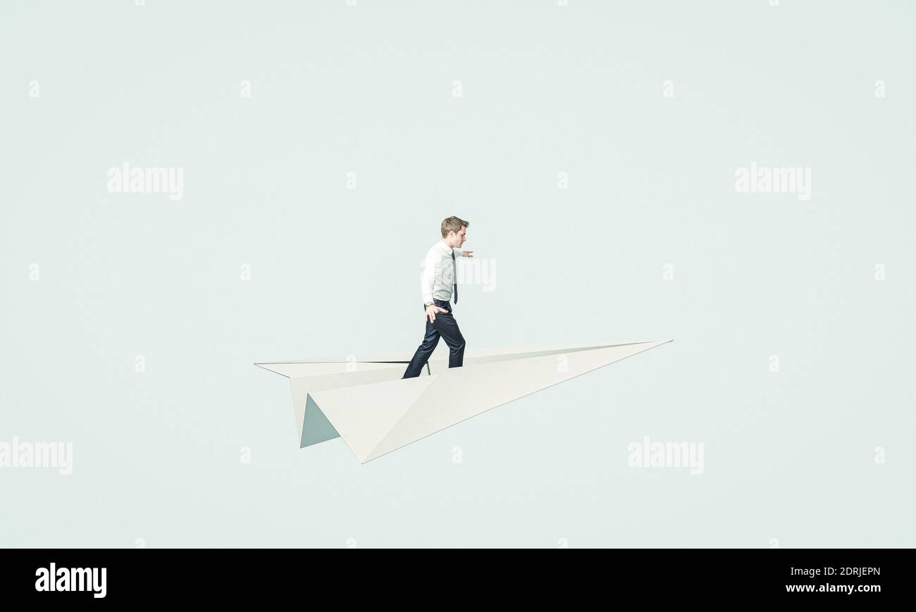 young business man flies on a paper plane. concept of unconventional solution and brainstorming Stock Photo