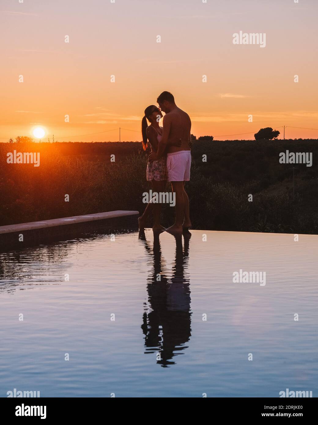 couple on vacation at luxury resort in Sicily during sunset by the ...