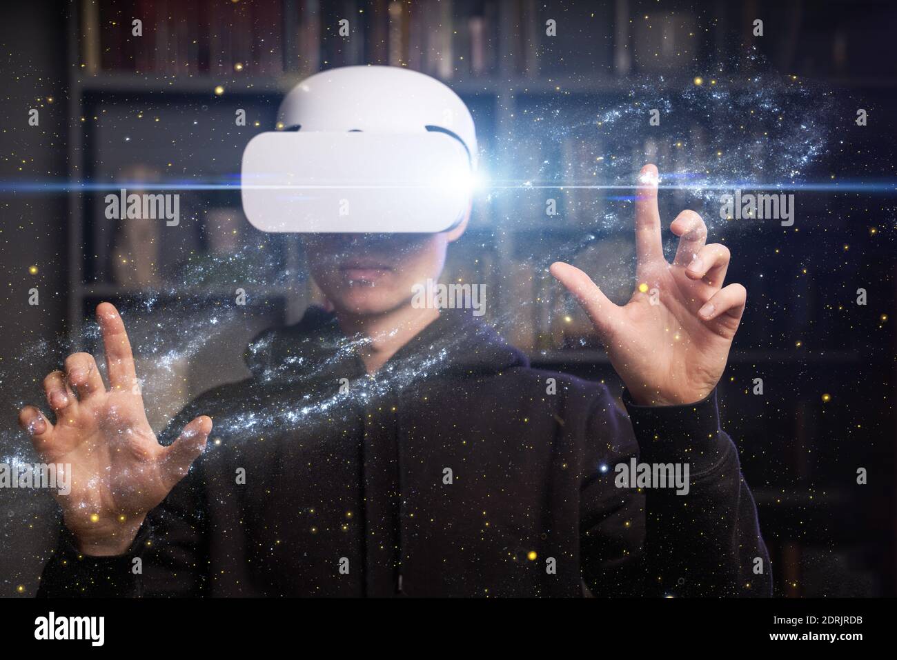 Man uses virtual reality glasses to see the galaxy space. Elements of ...