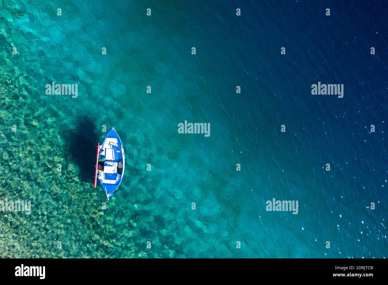 Top view of sail boat in Mediterranean sea clear blue water with copy space tropical summer background Stock Photo