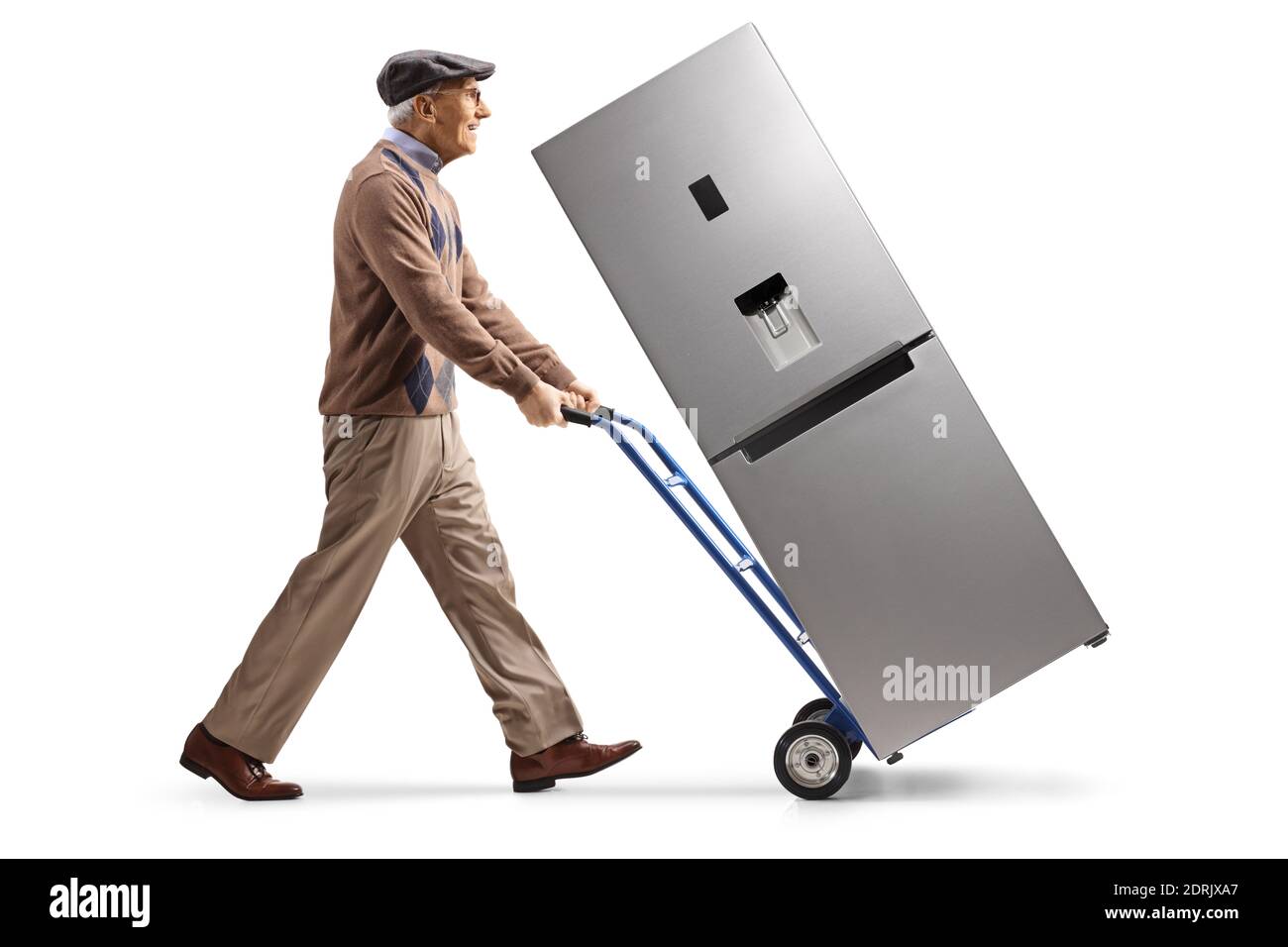 Full length profile shot of an elderly man pushing a refrigerator on a hand truck isolated on white background Stock Photo