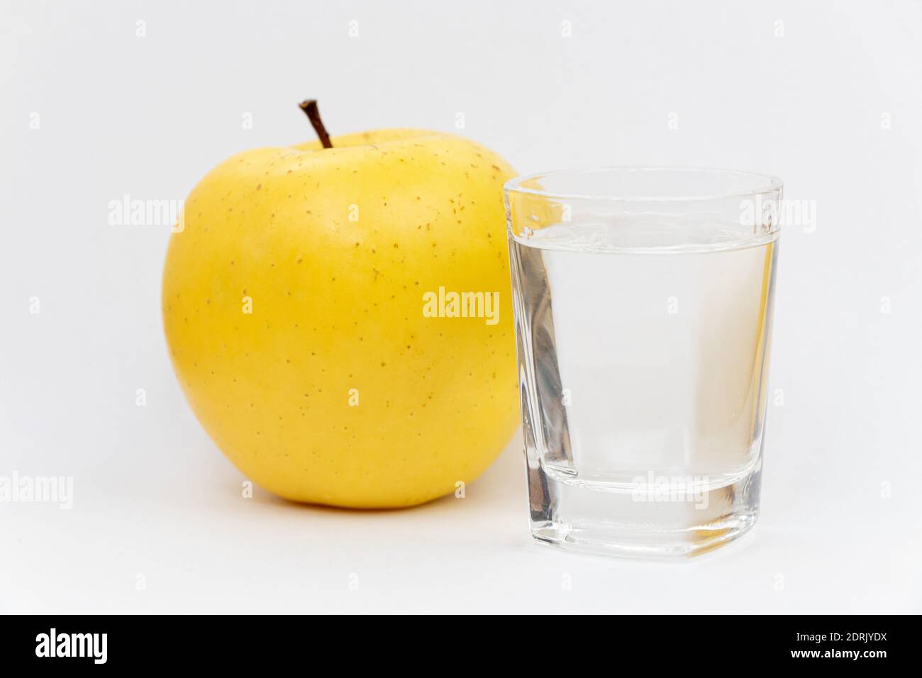 Apple alcohol drink in a glass. Rakija was made from golden delicious apples Stock Photo Alamy