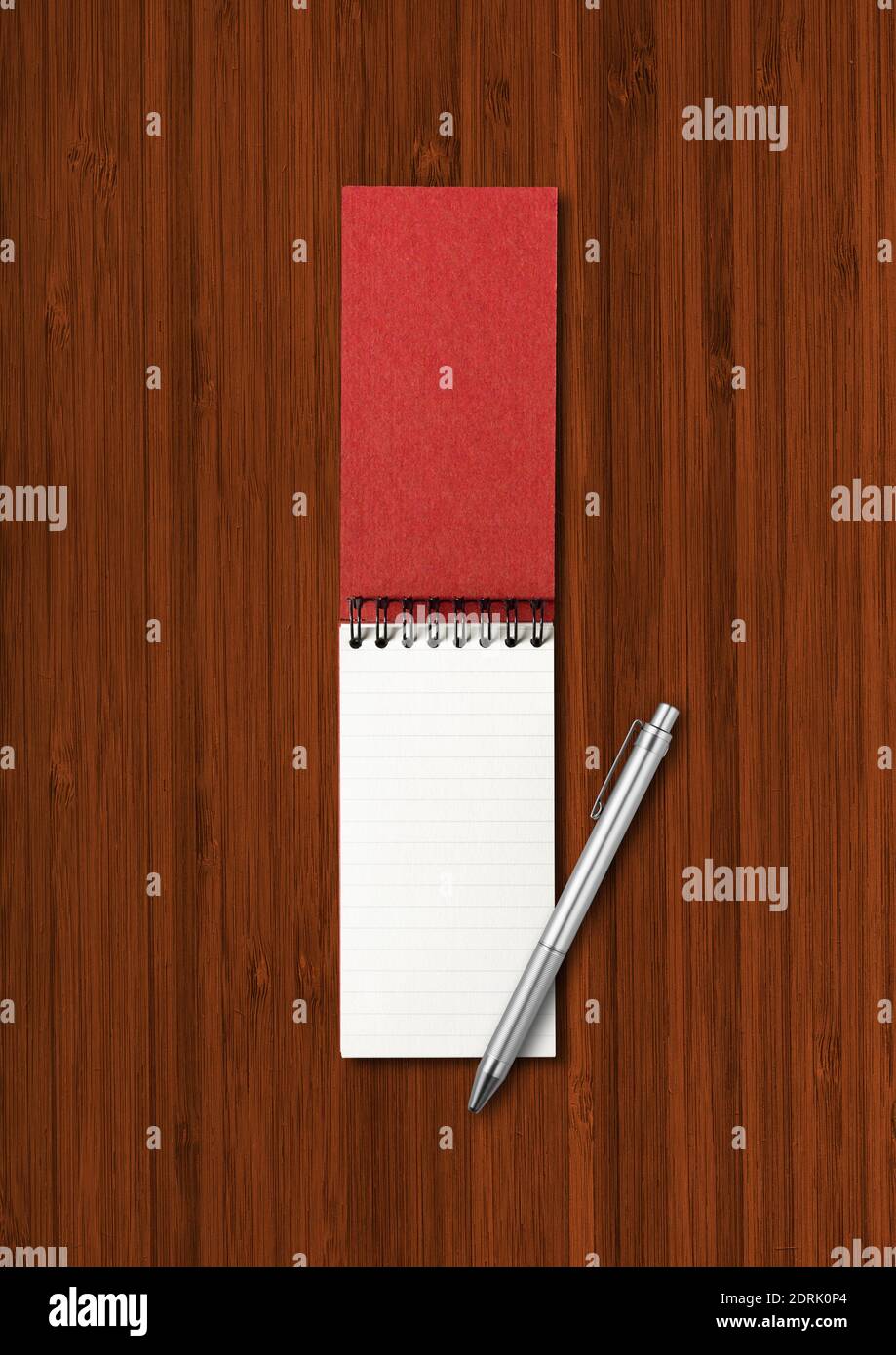 Blank open spiral notebook and pen mockup isolated on dark wood background Stock Photo