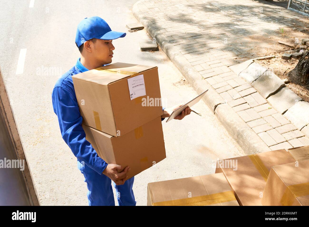 Courier unloading truck Stock Photo - Alamy