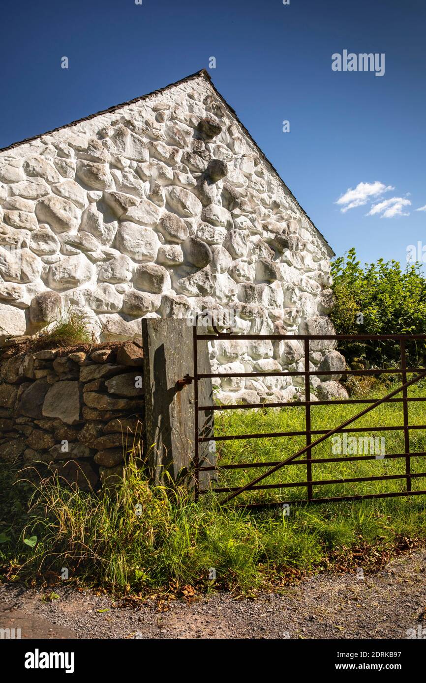 UK, Wales, Cardiff, St Fagans, National Museum of History, 1752 Llainfadyn Cottage from Snowdonia, built with large stone boulders, gate into field Stock Photo