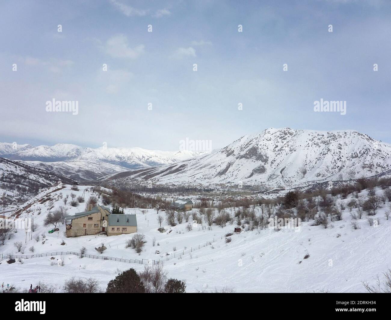 Snowy Chimgan Mountains, a lonely house stands in winter among the mountains Stock Photo