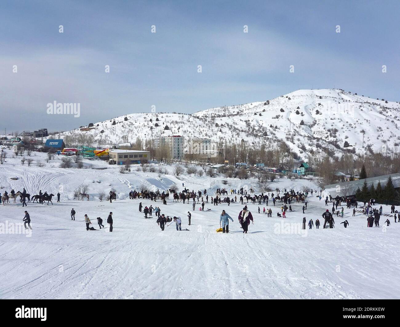 Snowy Chimgan mountains on a sunny day, people climb the mountain and ride  sleds and horses, Uzbekistan Chimgan Mountains, December 2019 Stock Photo -  Alamy