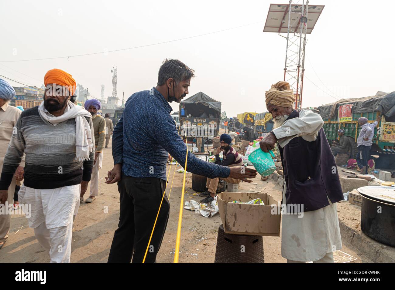 an aged farmer serving the food during protest at delhi border. Stock Photo