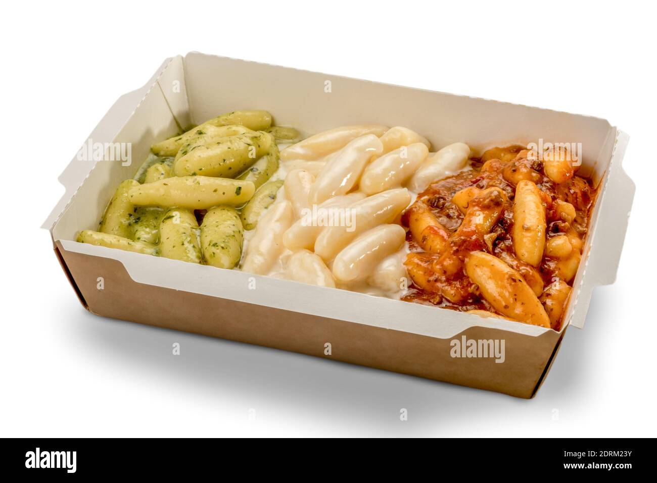 potato gnocchi in a take-away cardboard box topped with tomato sauce, melted cheese and Genoese pesto. Green white and red mimic the Italian flag Stock Photo