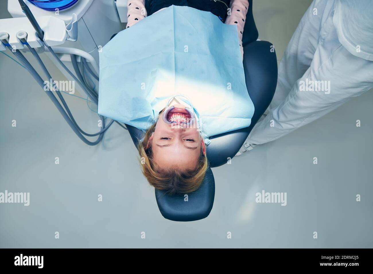 Portrait of young patient in dentist office. Girl during dental examination. Stock Photo
