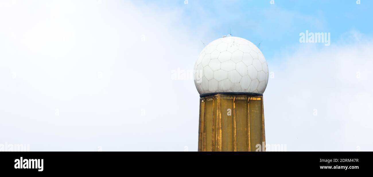 A tower with a radar dome on cloudy sky background Stock Photo - Alamy