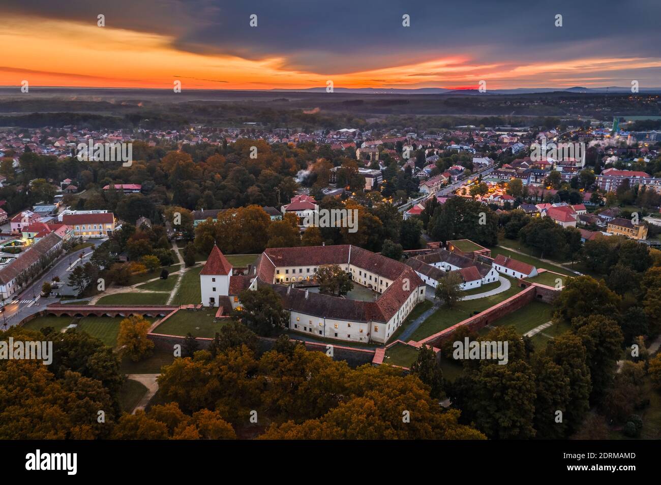 Sarvar, Hungary - Aerial panoramic view of the Castle of Sarvar (Nadasdy castle) with Sarvar Arboretum, a beautiful dramatic sunrise and rain clouds a Stock Photo