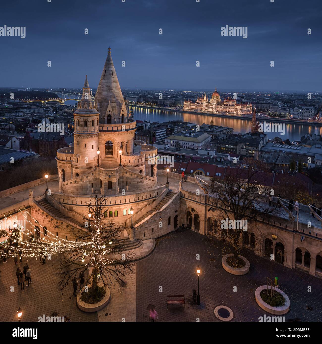 Budapest, Hungary - Aerial view of the famous illuminated Fisherman's Bastion (Halaszbastya) with Parliament of Hungary and festive lights at blue hou Stock Photo