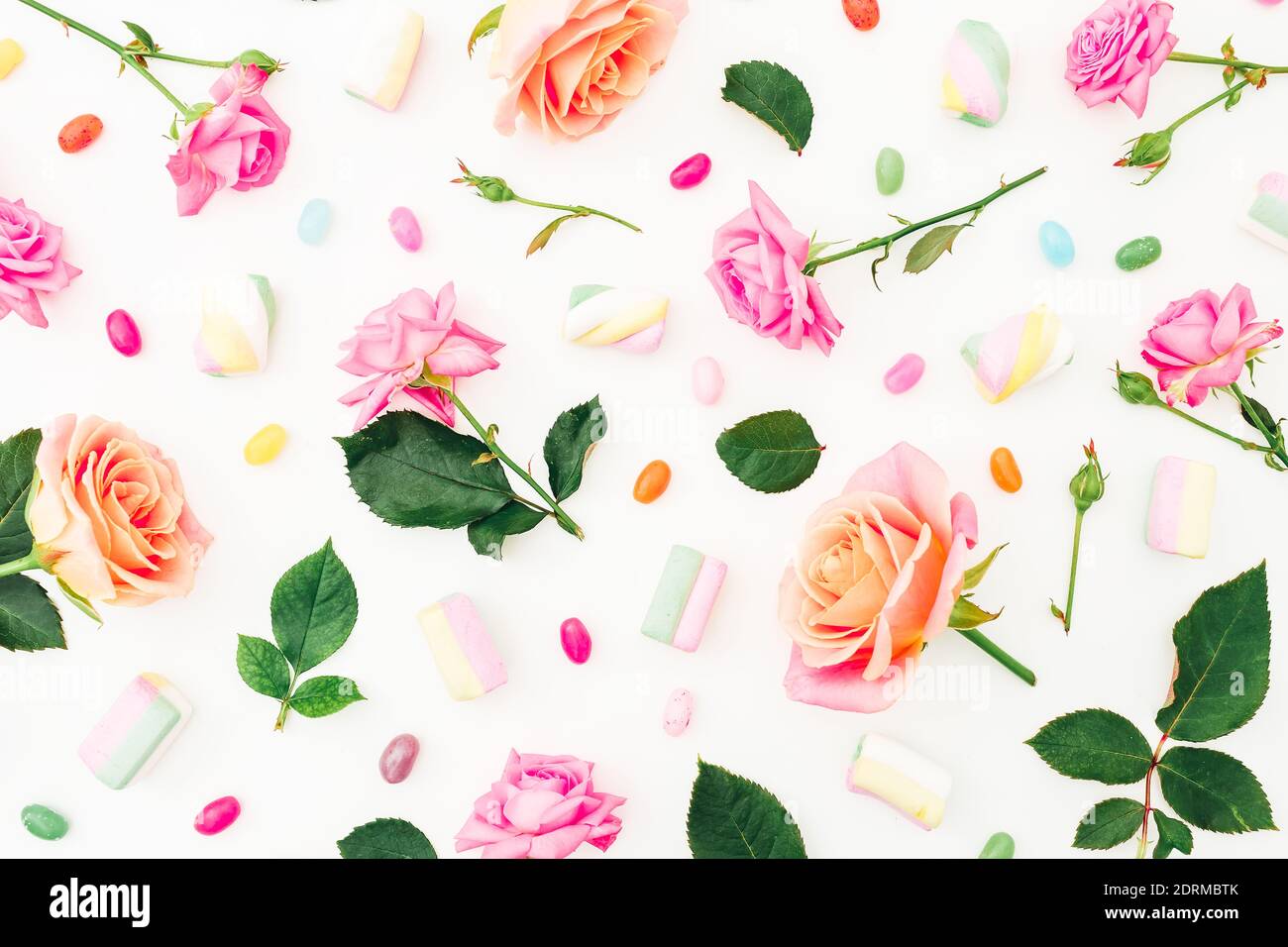 Colorful Pattern Of Roses Flowers And Marshmallow With Candy On White Background Flat Lay Top