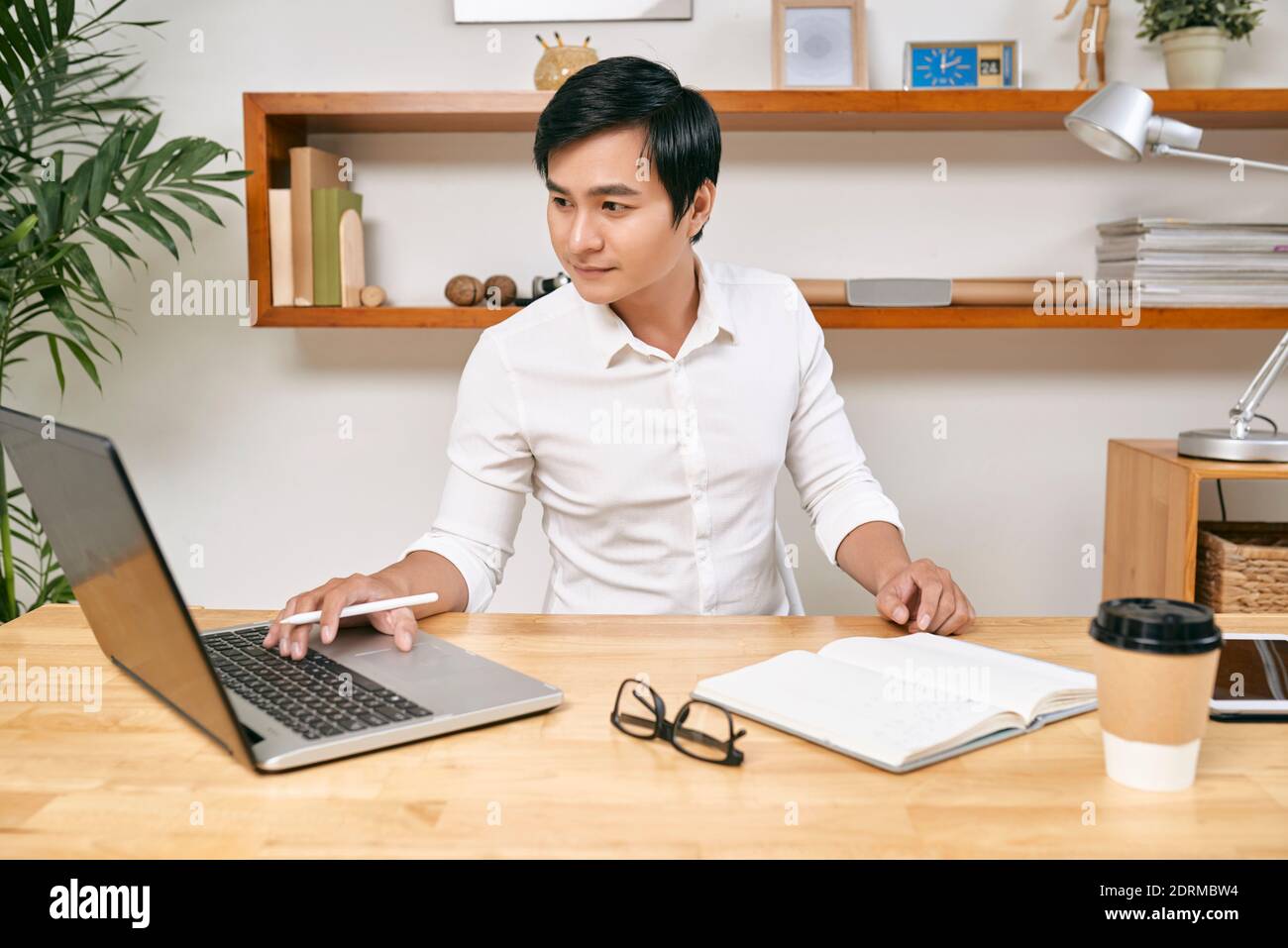 Businessman checking data on laptop Stock Photo