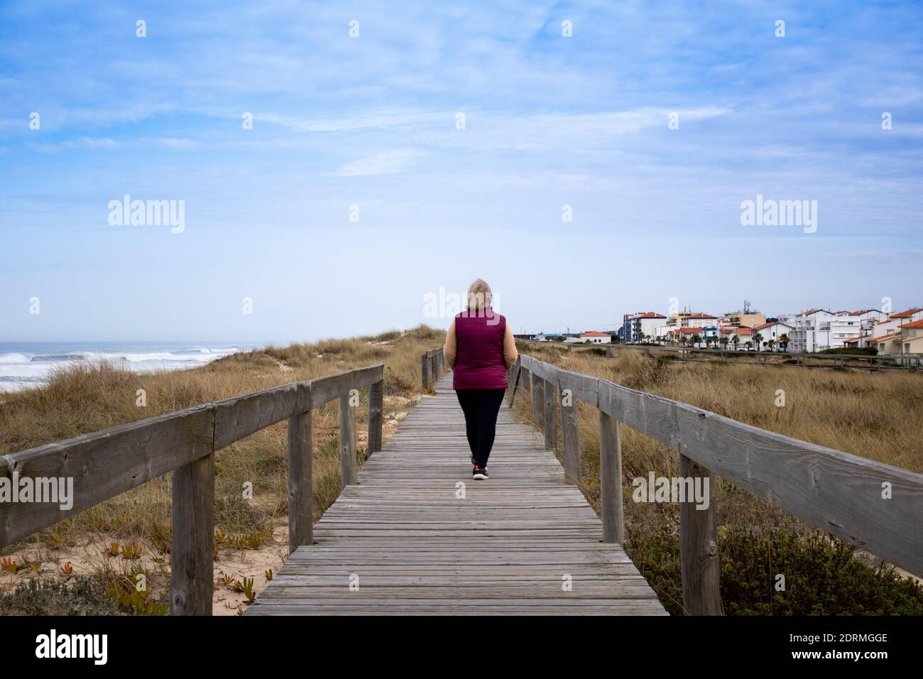 Woman walking alone on a path hi-res stock photography and images - Alamy