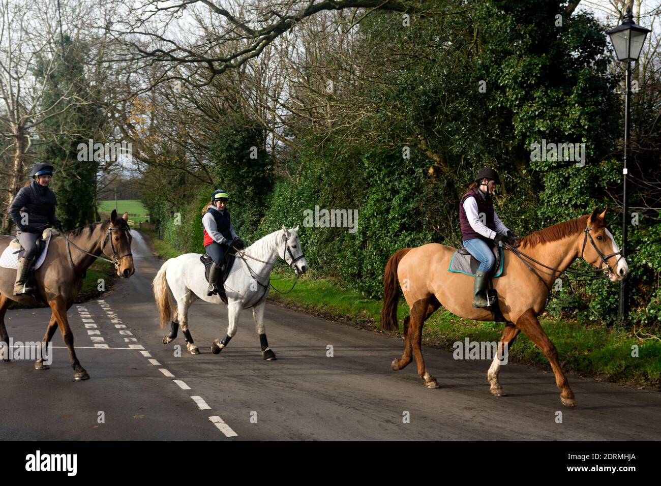 Horse riders in winter, Sherbourne village, Warwickshire, England, UK Stock Photo