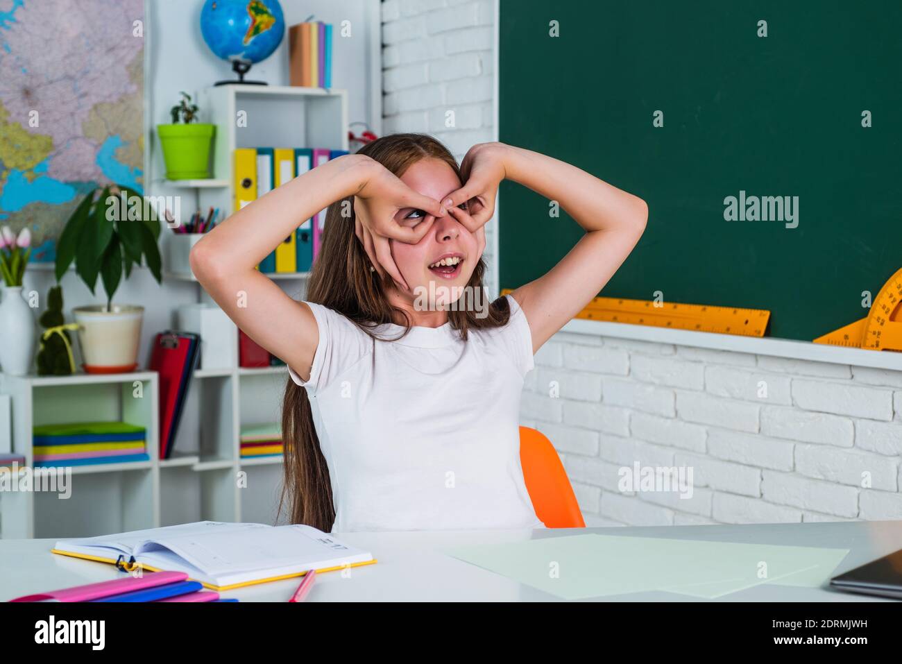 funny kid work in school classroom during modern education, lesson fun ...