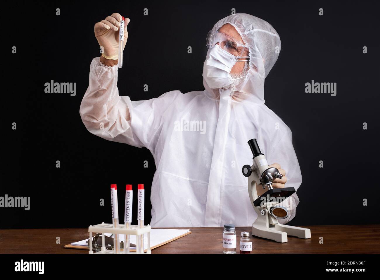 male scientist is testing a sample of biological tubes contaminated by ...