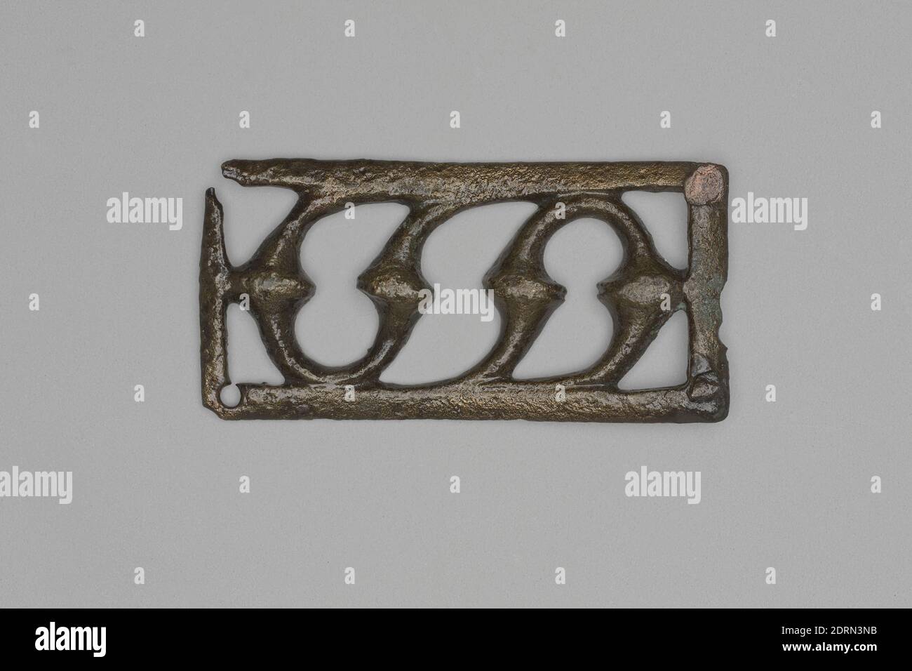 Pierced Bronze Decoration (Roman military belt plate), A.D. 165–256, Bronze, , 2.65 × 5.3 × 0.4 cm (1 1/16 × 2 1/16 × 3/16 in.), Yale-French Excavations at Dura-Europos, Excavated in Dura-Europos, Syria, Syrian, Dura-Europos, Roman, Jewelry Stock Photo
