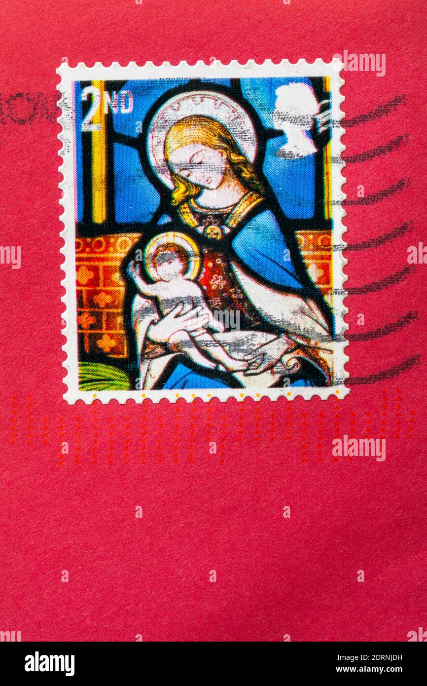 2nd class Christmas stamp with Madonna and child stuck on red envelope