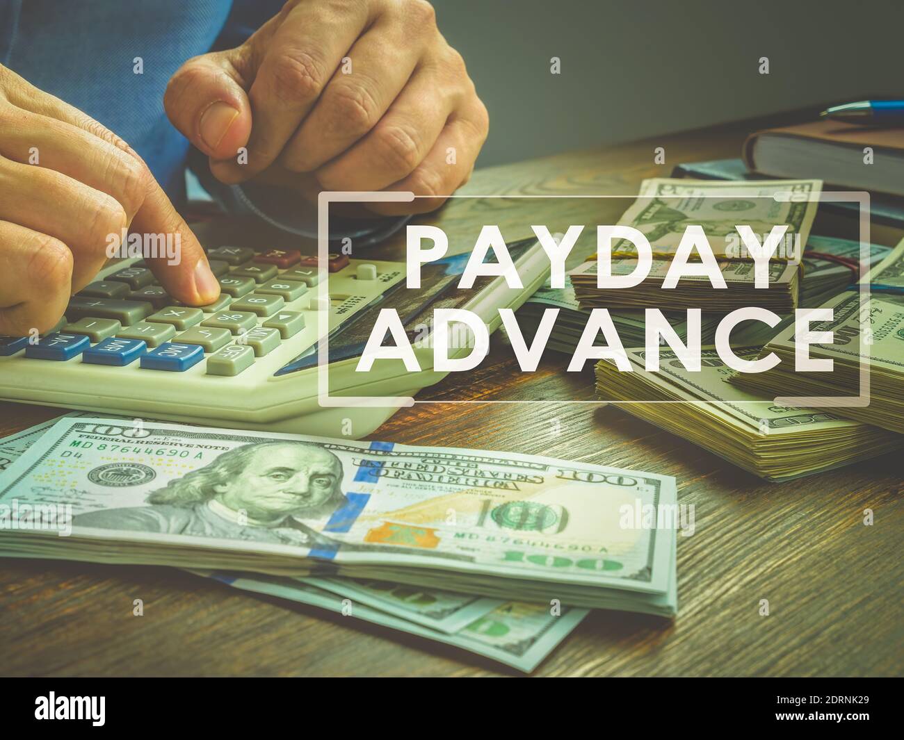 Payday advance loan concept. Calculator and wads of money. Stock Photo