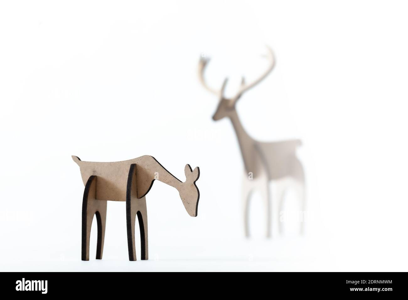 Reindeer stag and young deer cardboard toy isolated on a white background. Christmas icon and shapes with text space Stock Photo