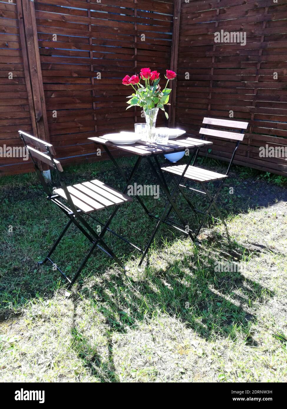 Empty Seats And Table Against Wooden Wall Stock Photo - Alamy