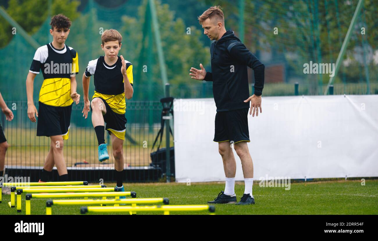 Ladder Drills for Soccer. Group of Young Boys on Football Training With Coach. Young Man as a Sports Trainer Showing to Male Youth Soccer Team how to Stock Photo