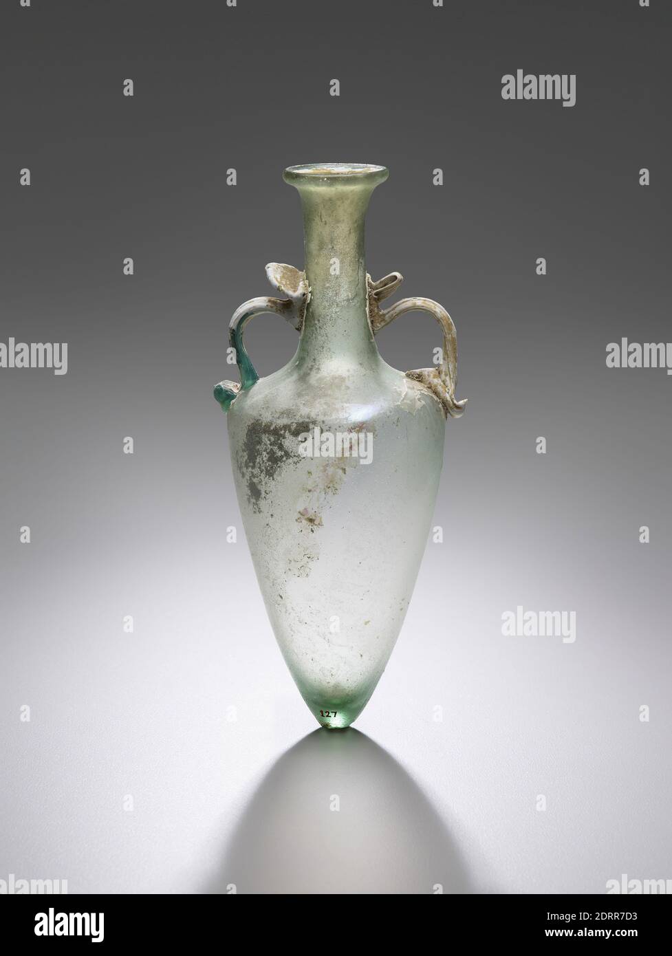 Flask, 3rd–4th century A.D., Free-blown glass, bluish green, 17.78 × 8.13 × 6.88 cm (7 × 3 3/16 × 2 11/16 in.), Eastern Mediterranean, Roman, Containers - Glass Stock Photo