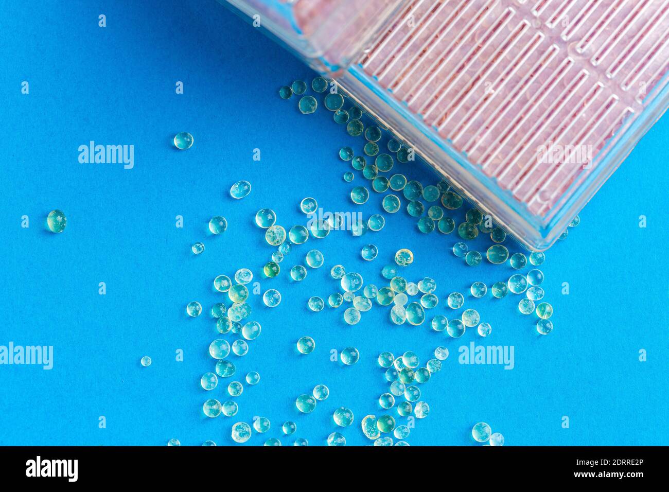 Boxes with silica gel absorbs moisture on blue background Stock Photo