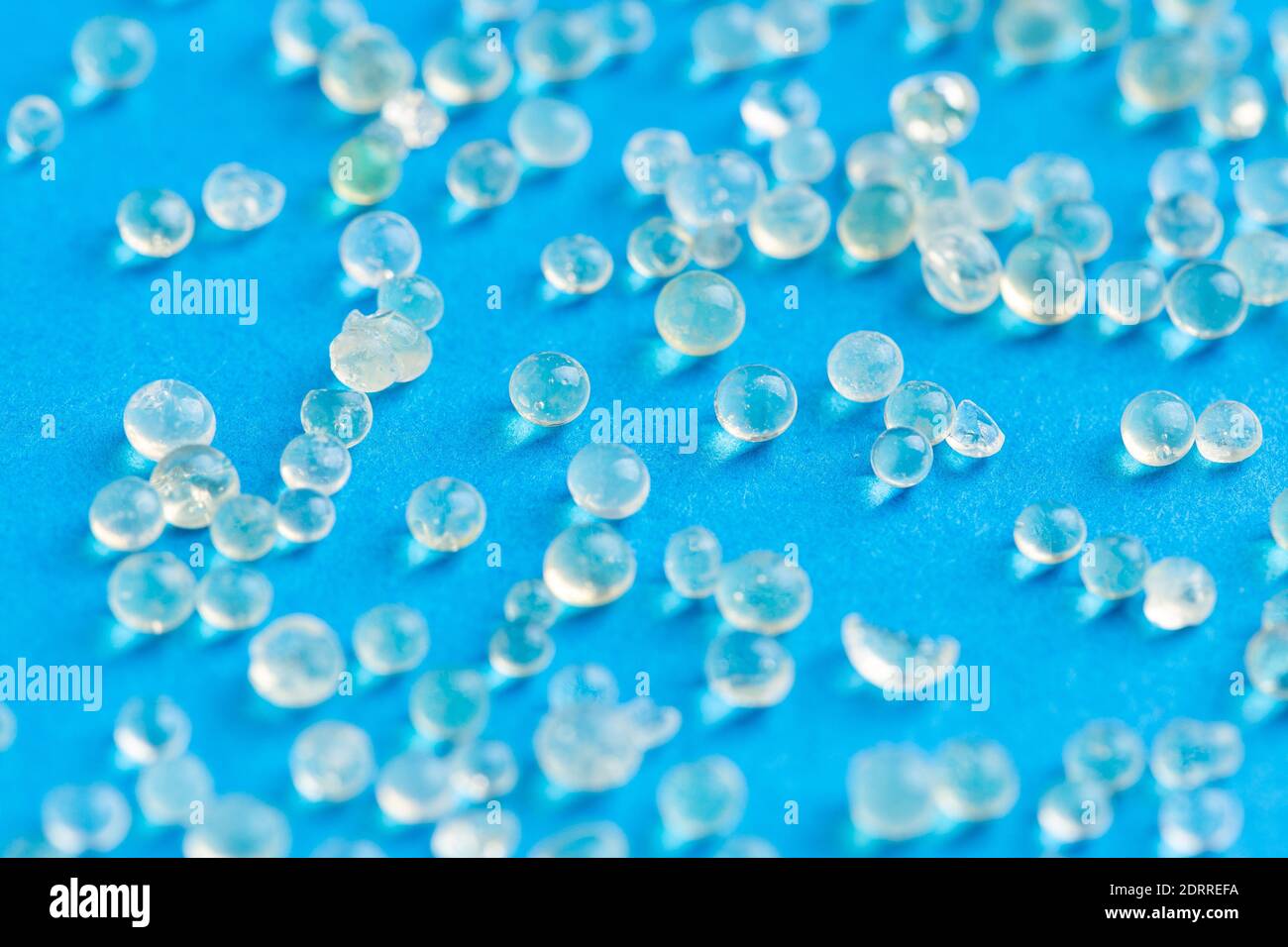 Many white silica gel on blue background Stock Photo