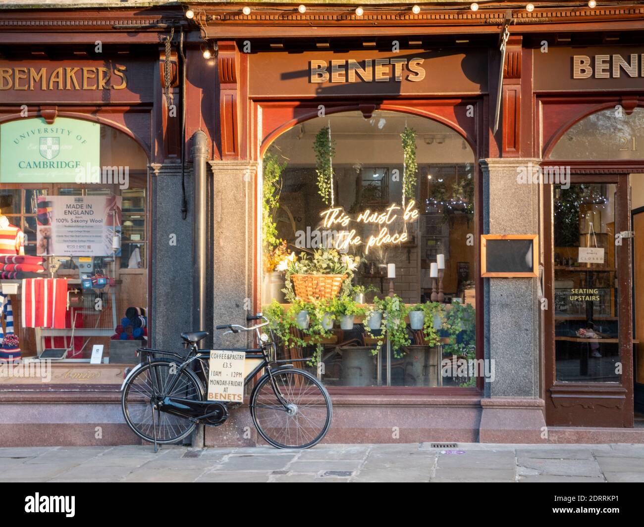 The front of Benets cafe in Kings Parade Cambridge UK with a parked bicycle and signs advertising the restaurant. Stock Photo