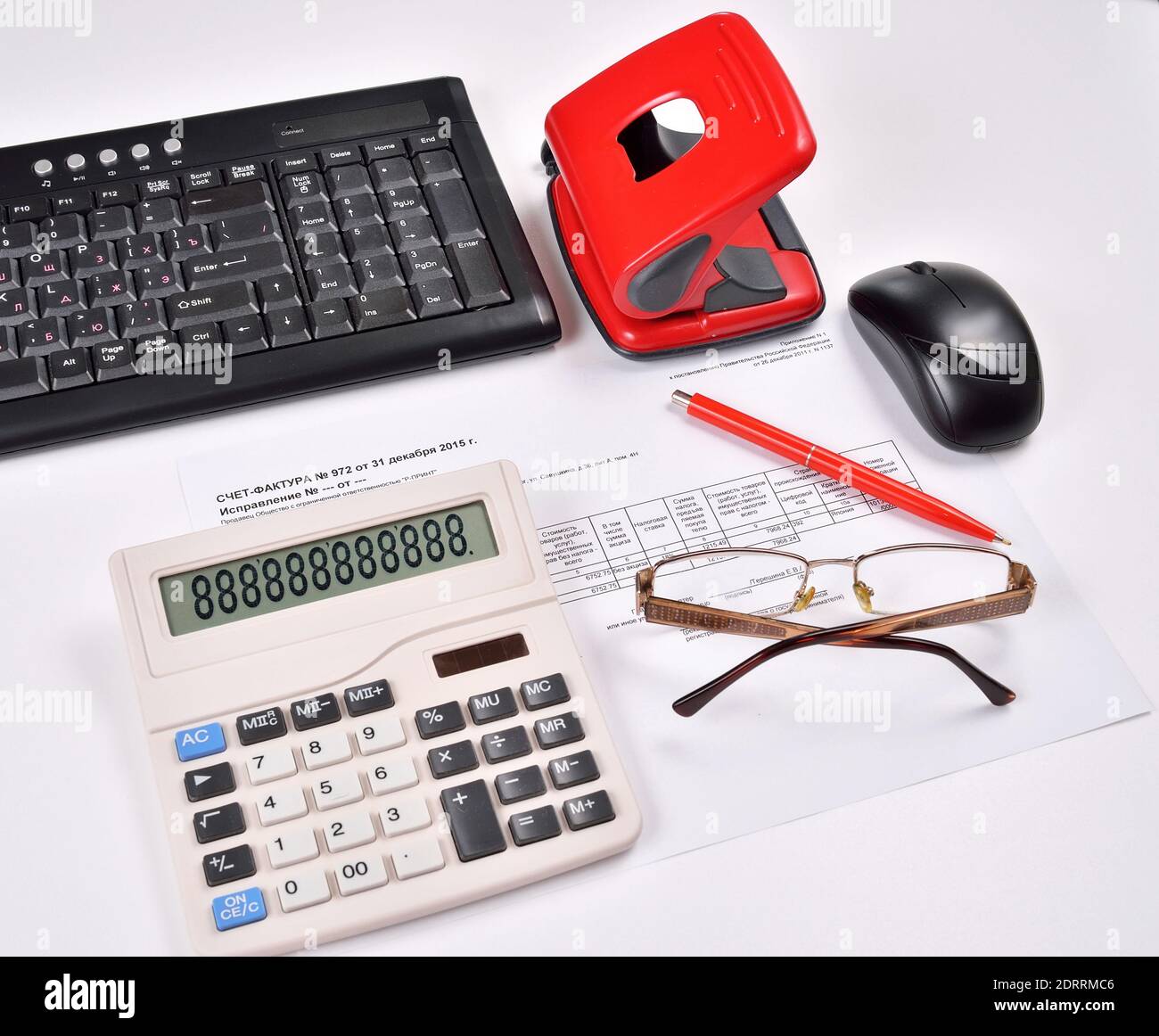 Table accounting invoice, keyboard, calculator, mouse, hole punch