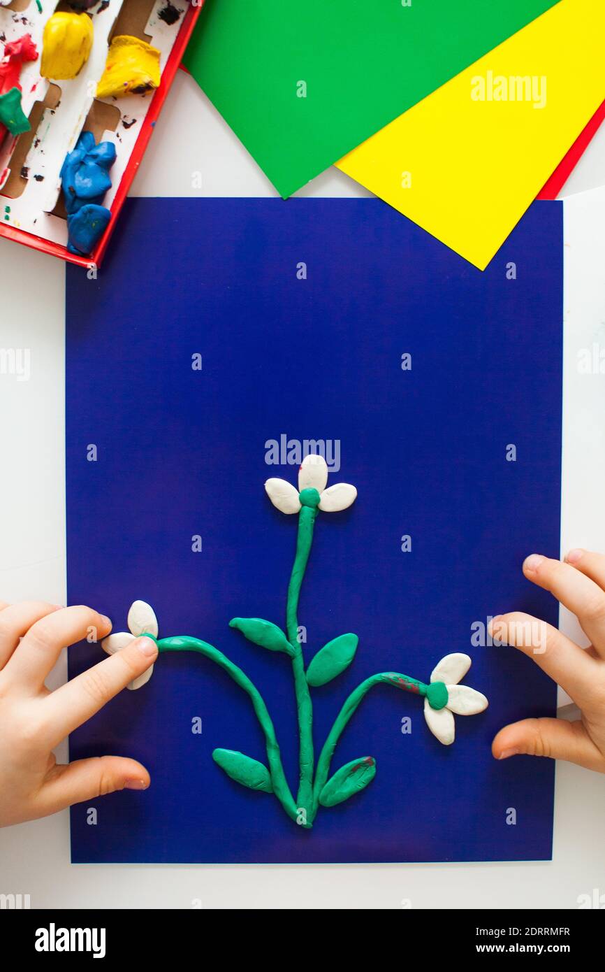 step-by-step instructions for children's crafts made of plasticine. Making  a snowdrop step 4. paper with space for text Stock Photo - Alamy