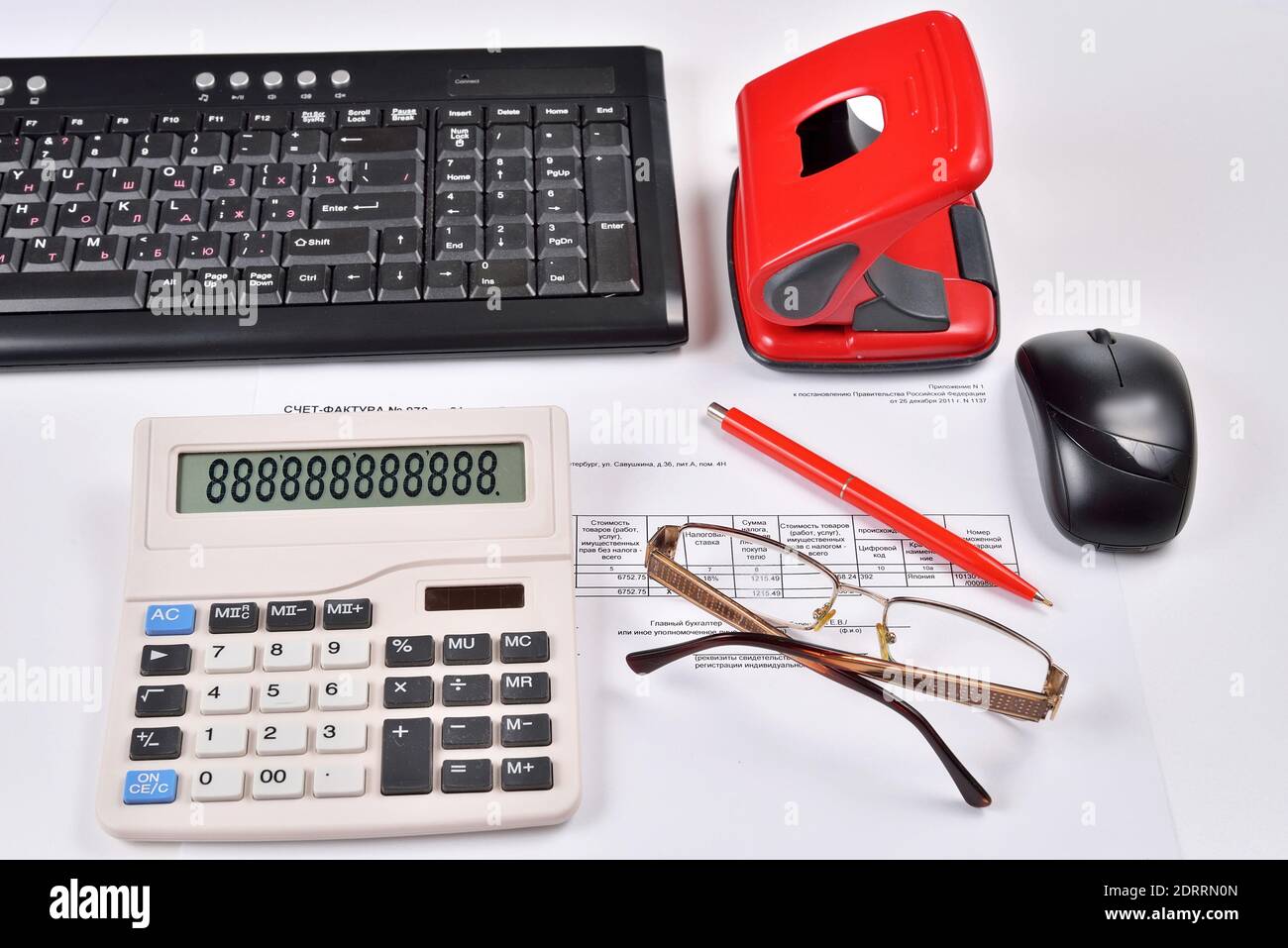 Accounting invoice, keyboard, calculator, mouse, hole punch, glasses