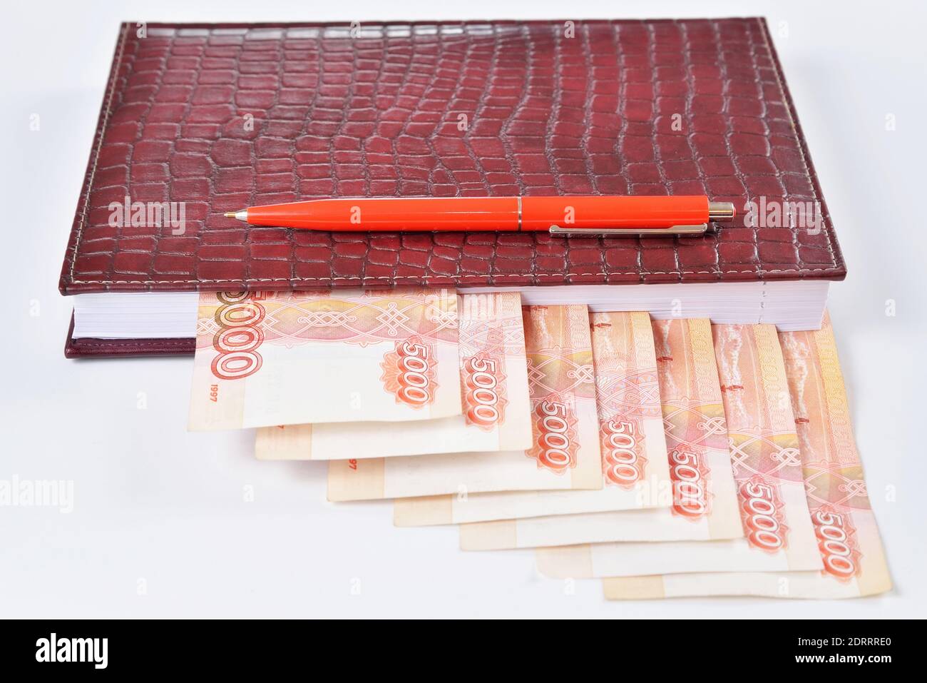 Close-up: leather diary with bookmarks out of money and fountain pen  Office supplies and . Stock Photo