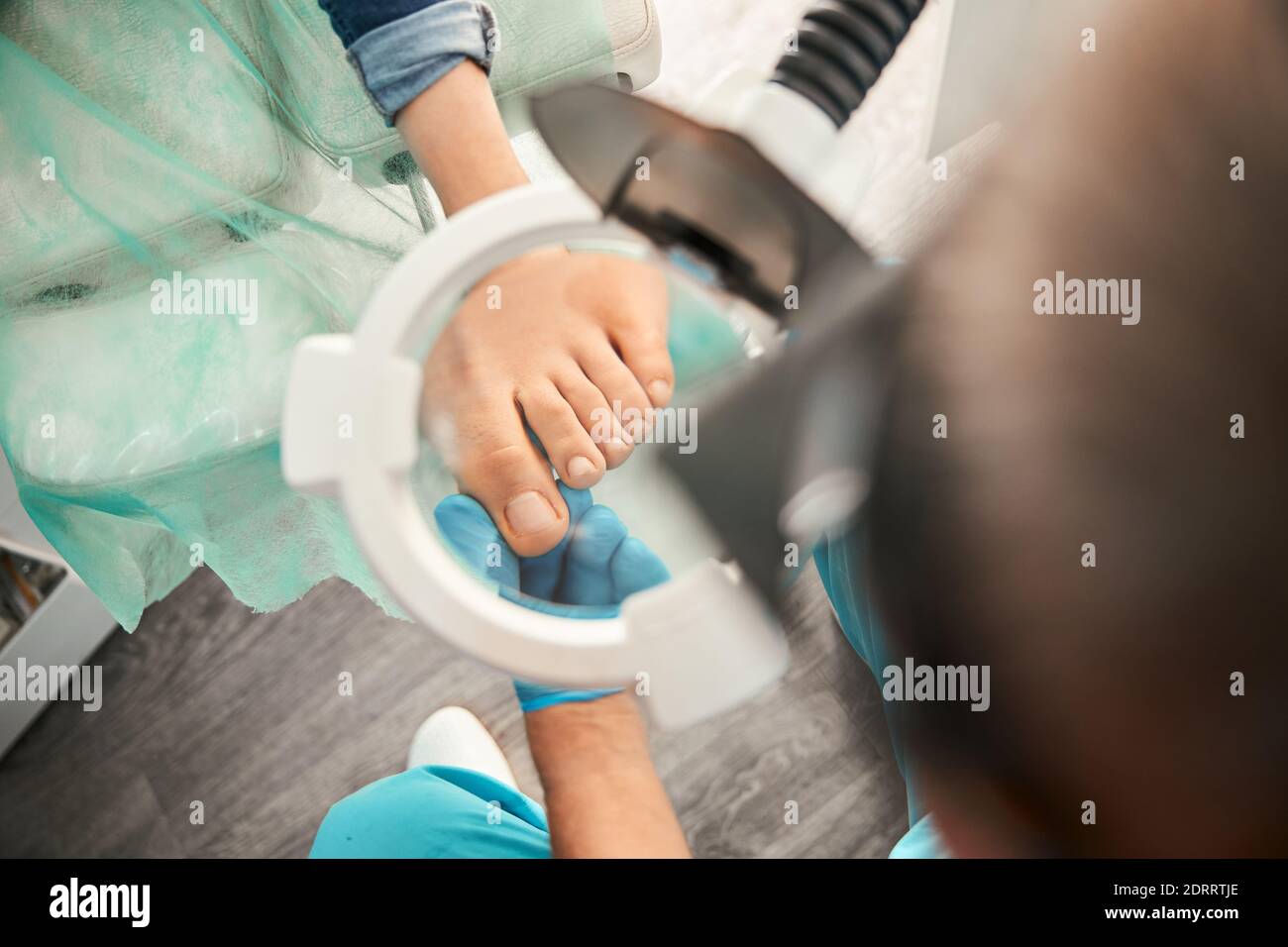 Attentive medical worker looking through magnifying glass Stock Photo