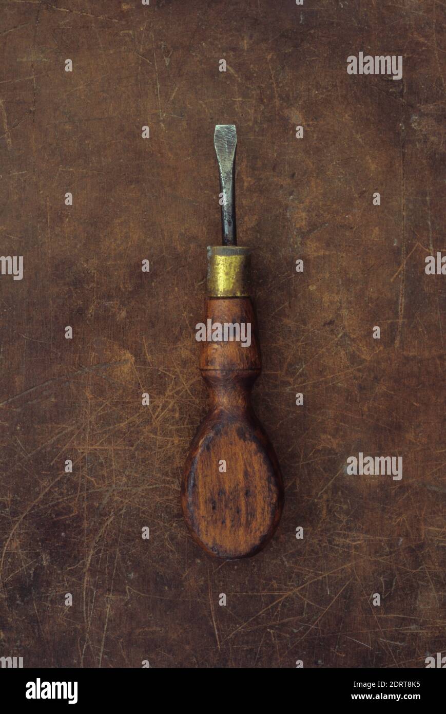 Vintage wellused screwdriver with wooden handle and brass ferrule