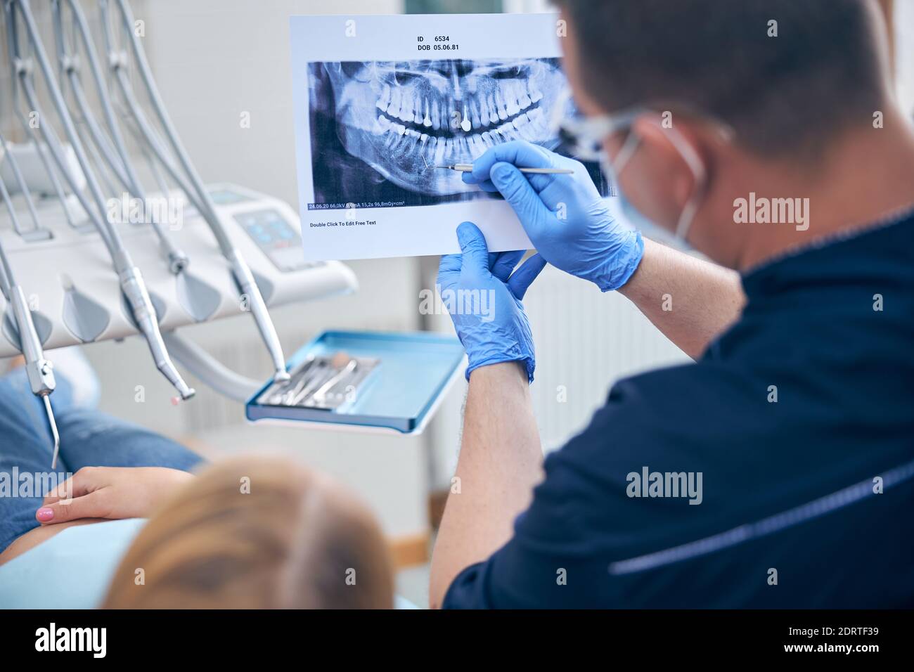 Surgeon with female discussing her jaw xray Stock Photo Alamy