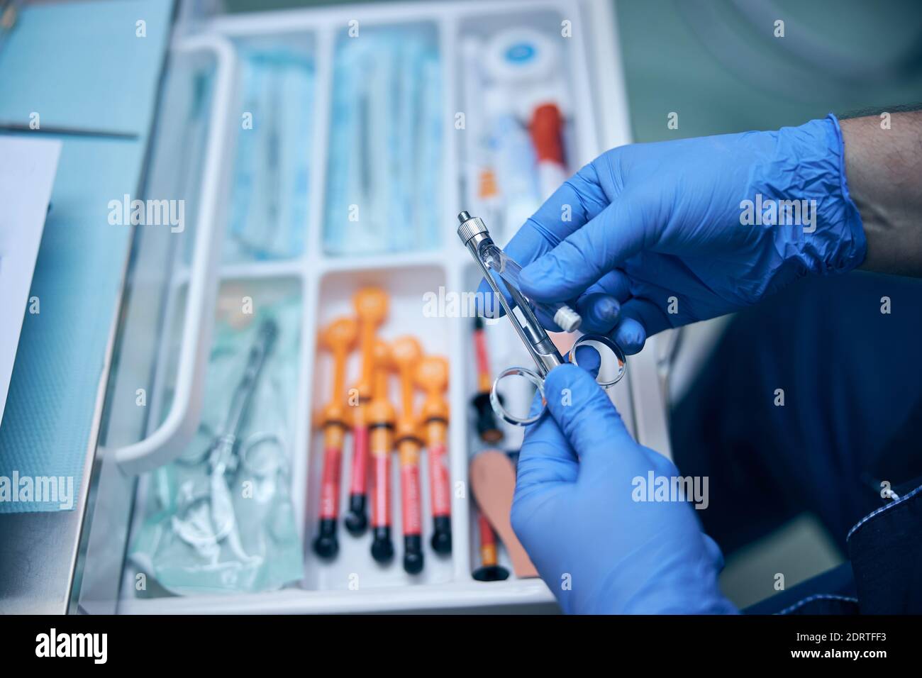 Male dentist preparing syringe for injection in office Stock Photo Alamy