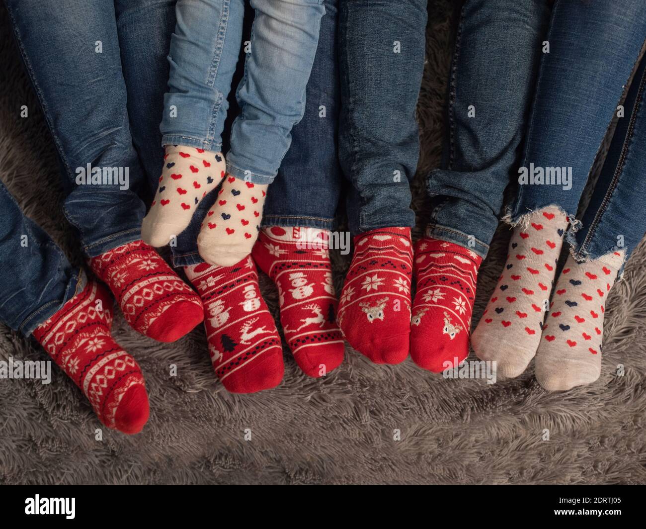 Christmas socks on the legs of the family. Stock Photo
