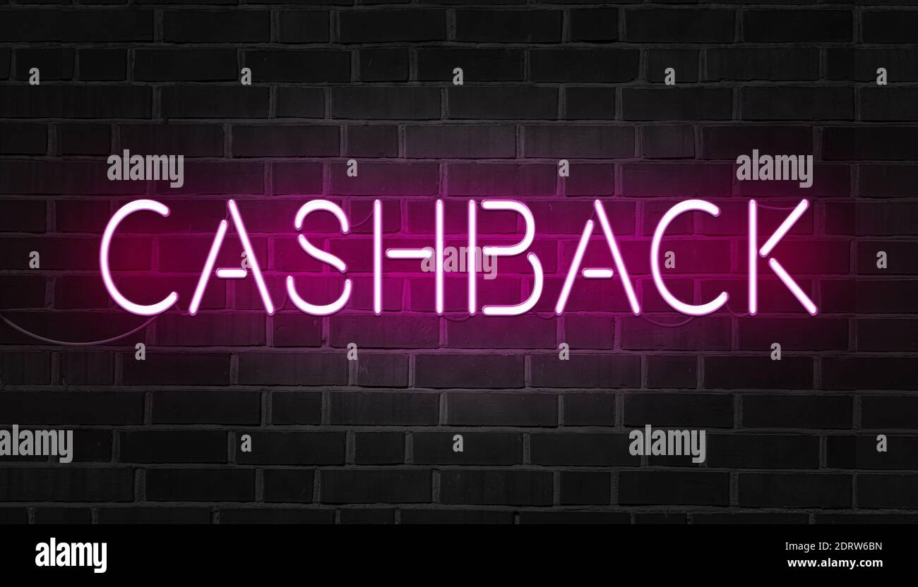 Pink neon sign of the word cashback on dark brick wall. Stock Photo